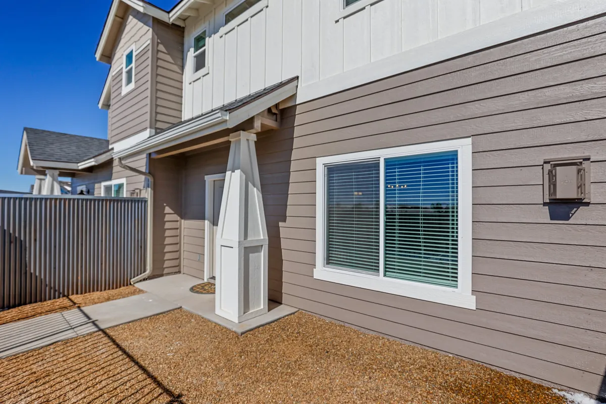The front porch is highlighted, along with a window and textured wall, suggesting a cozy spot for relaxing after a day of exploration. The setting is ideal for families to unwind together and enjoy the outdoors.