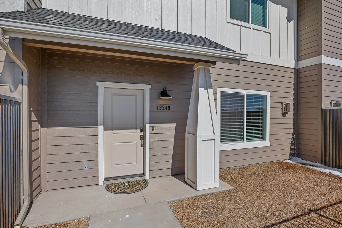 A clear view of the front door, welcome mat, and house number, this image captures the sense of arrival and the anticipation of new experiences. The decor and entryway are warm and inviting, setting the tone for memorable family stays.