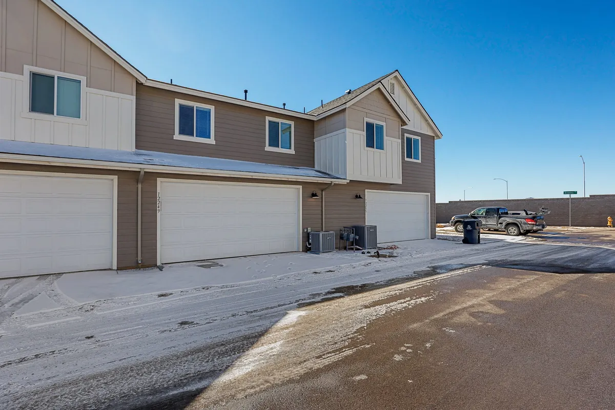 A practical exterior view shows garage doors and windows against a snow-covered ground, capturing the sense of easy and secure parking even during winter months. The setting evokes the Northern Arizona climate referenced in the section.
